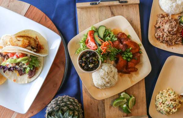 An overhead view of three plates of food.