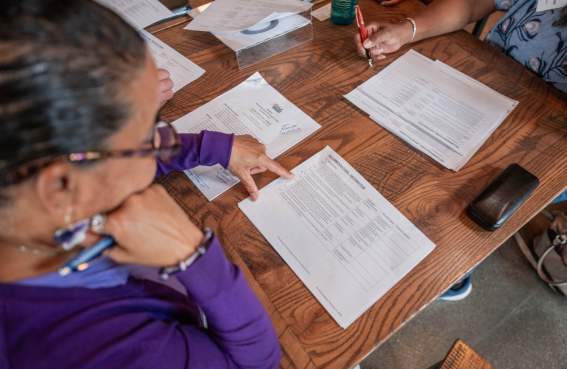 A woman reviewing a strategy document on a table.
